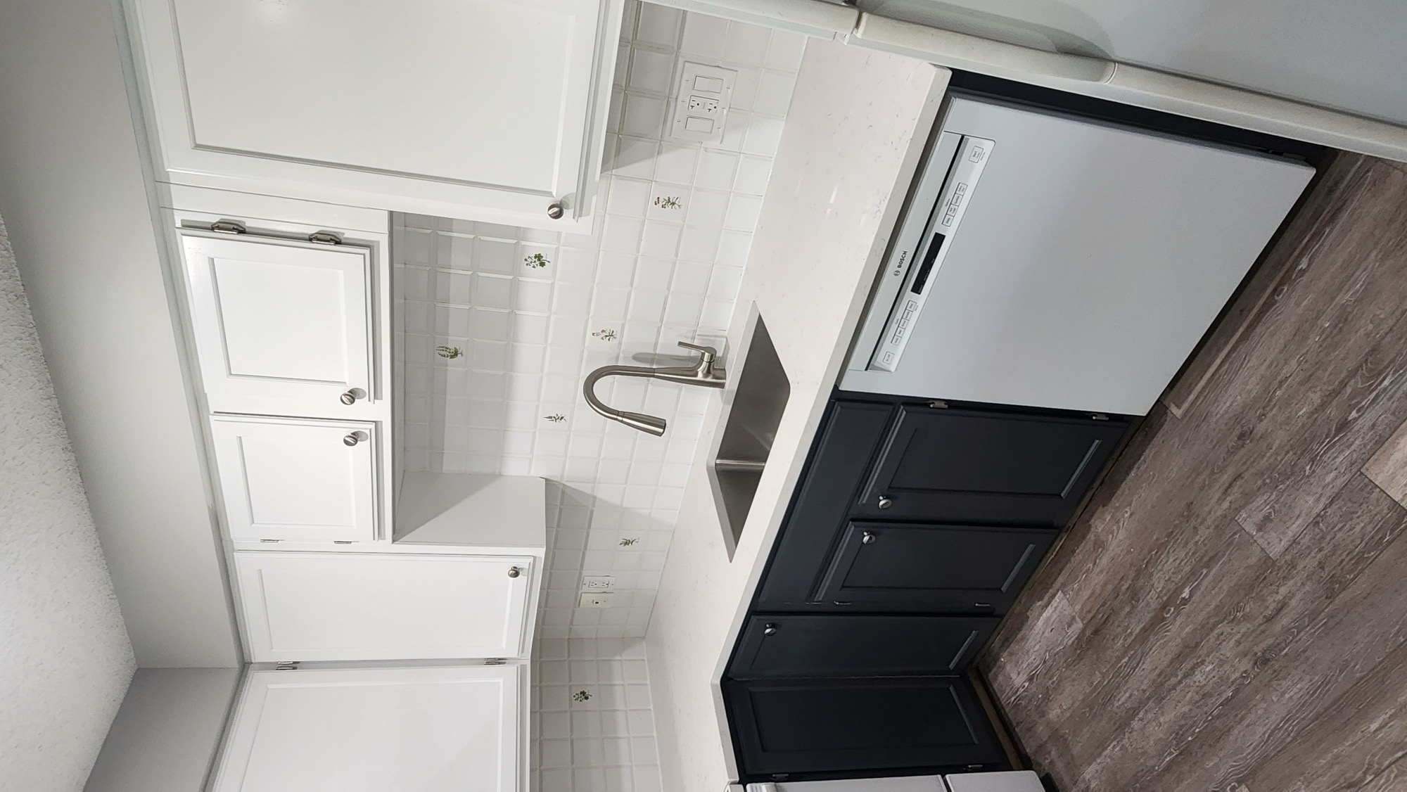 Two-tone kitchen with waterfall quartz island