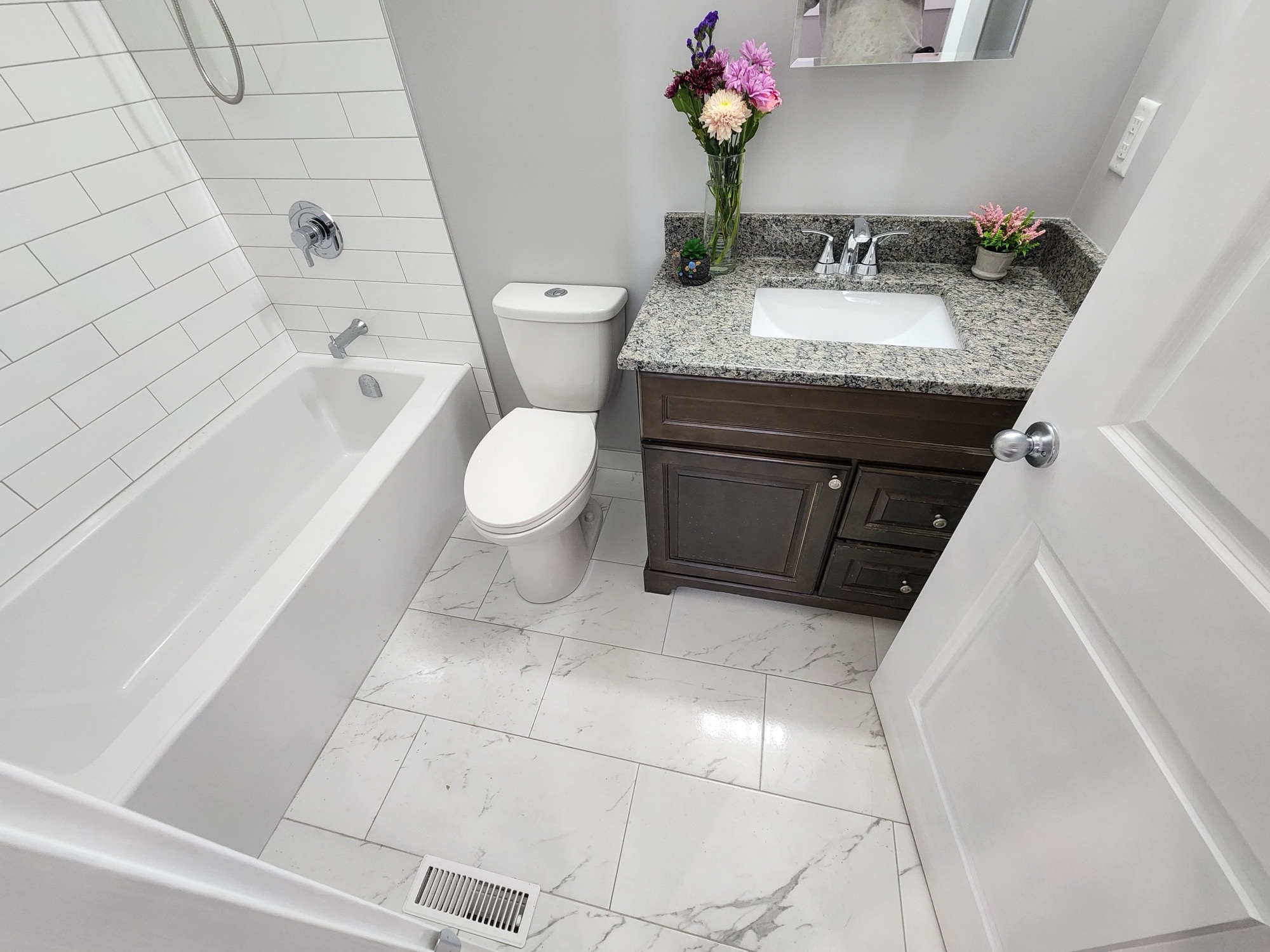 Full bathroom with tub, shower, and vanity