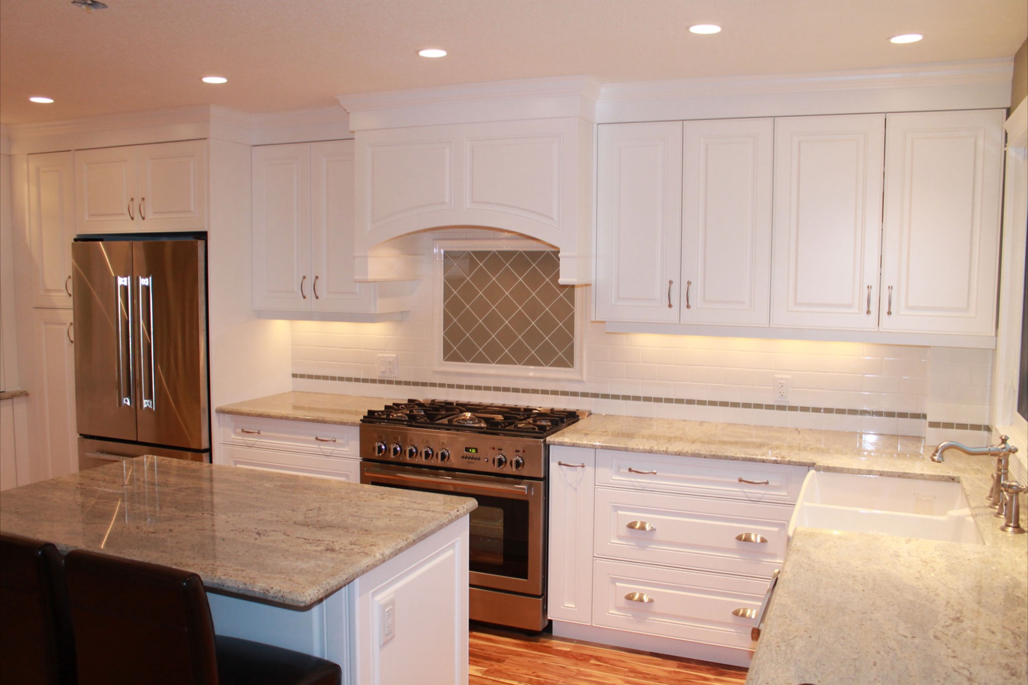 White kitchen with arched tiled range hood
