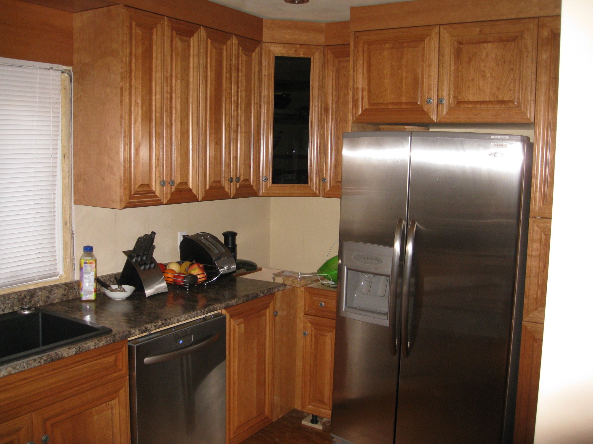 Tall pantry cabinetry beside a built-in refrigerator